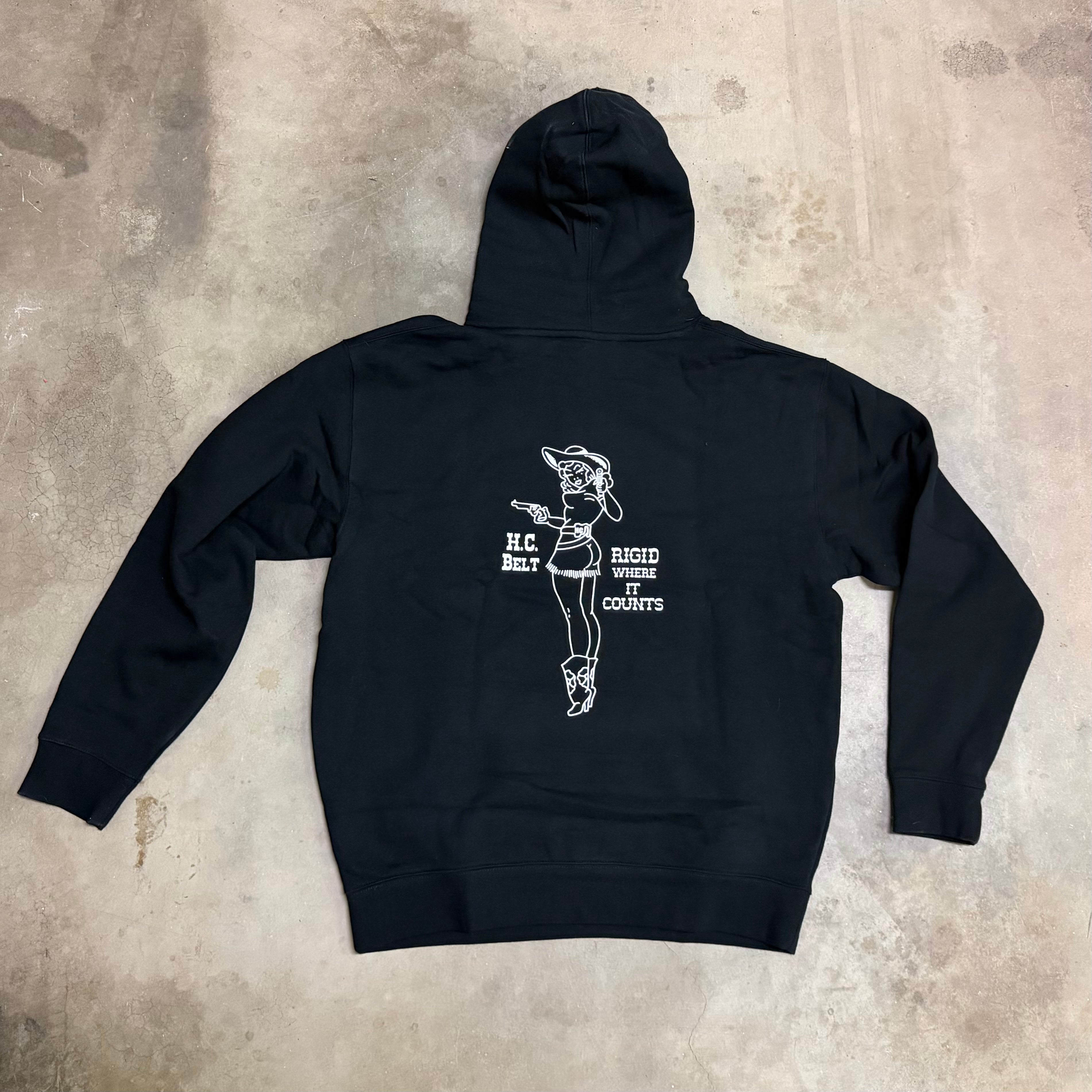 Black hoodie with white graphic design on a textured gray surface