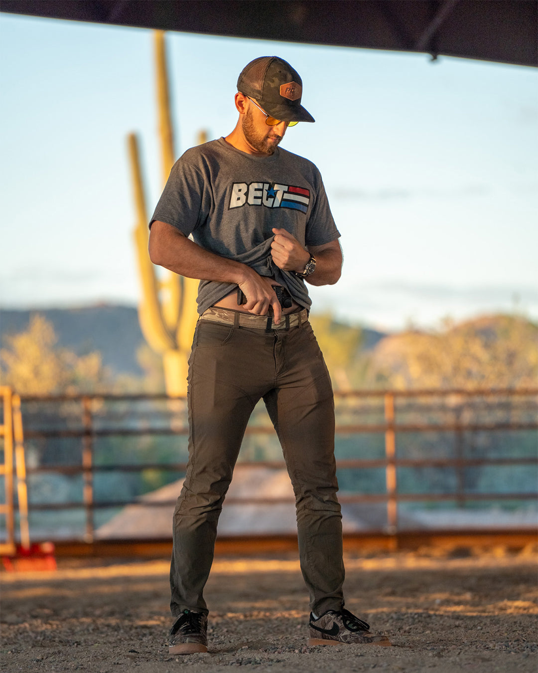 Man in the GI Belt Tee standing in the desert at sunset