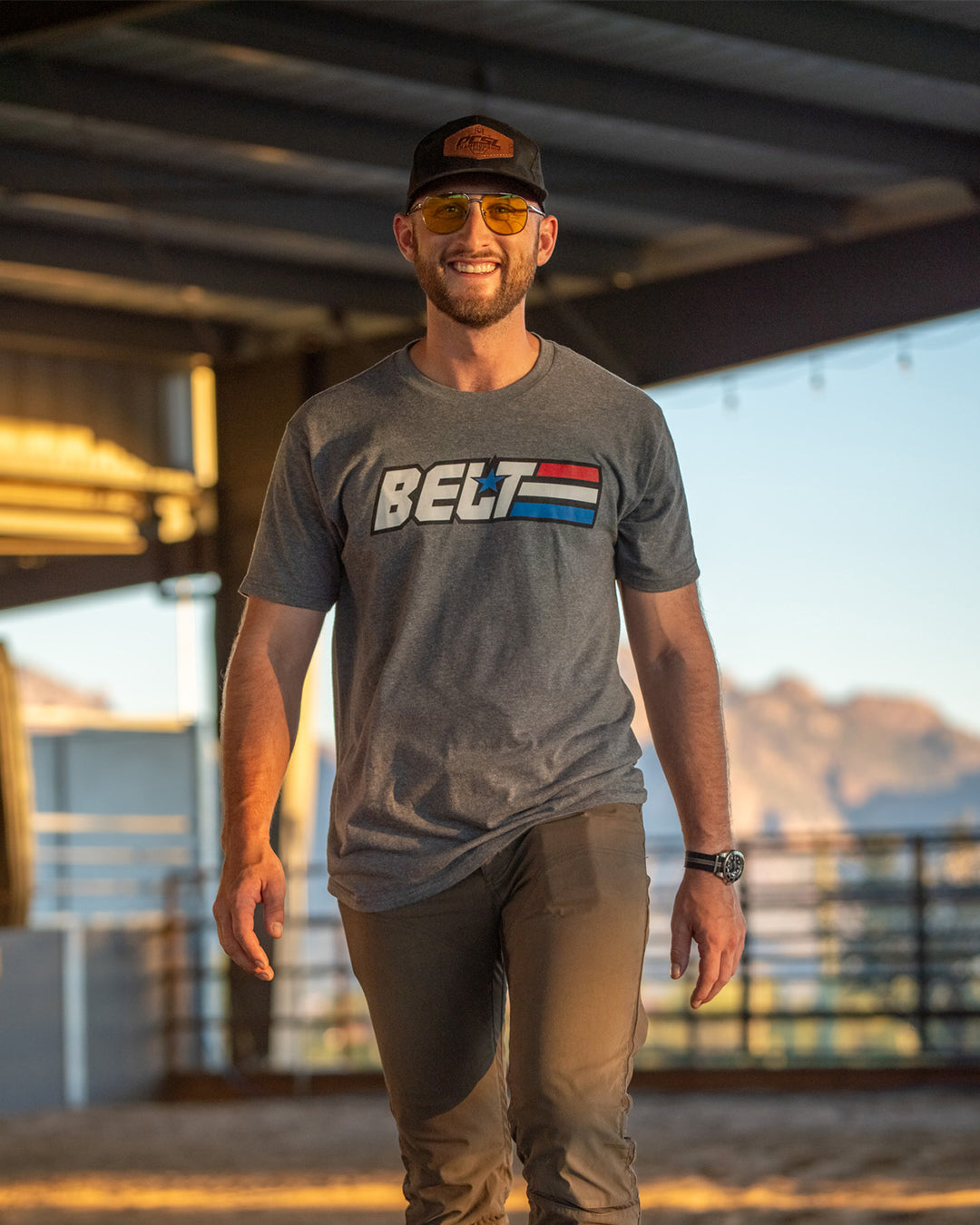 Smiling man on a covered patio in the GI Belt Tee