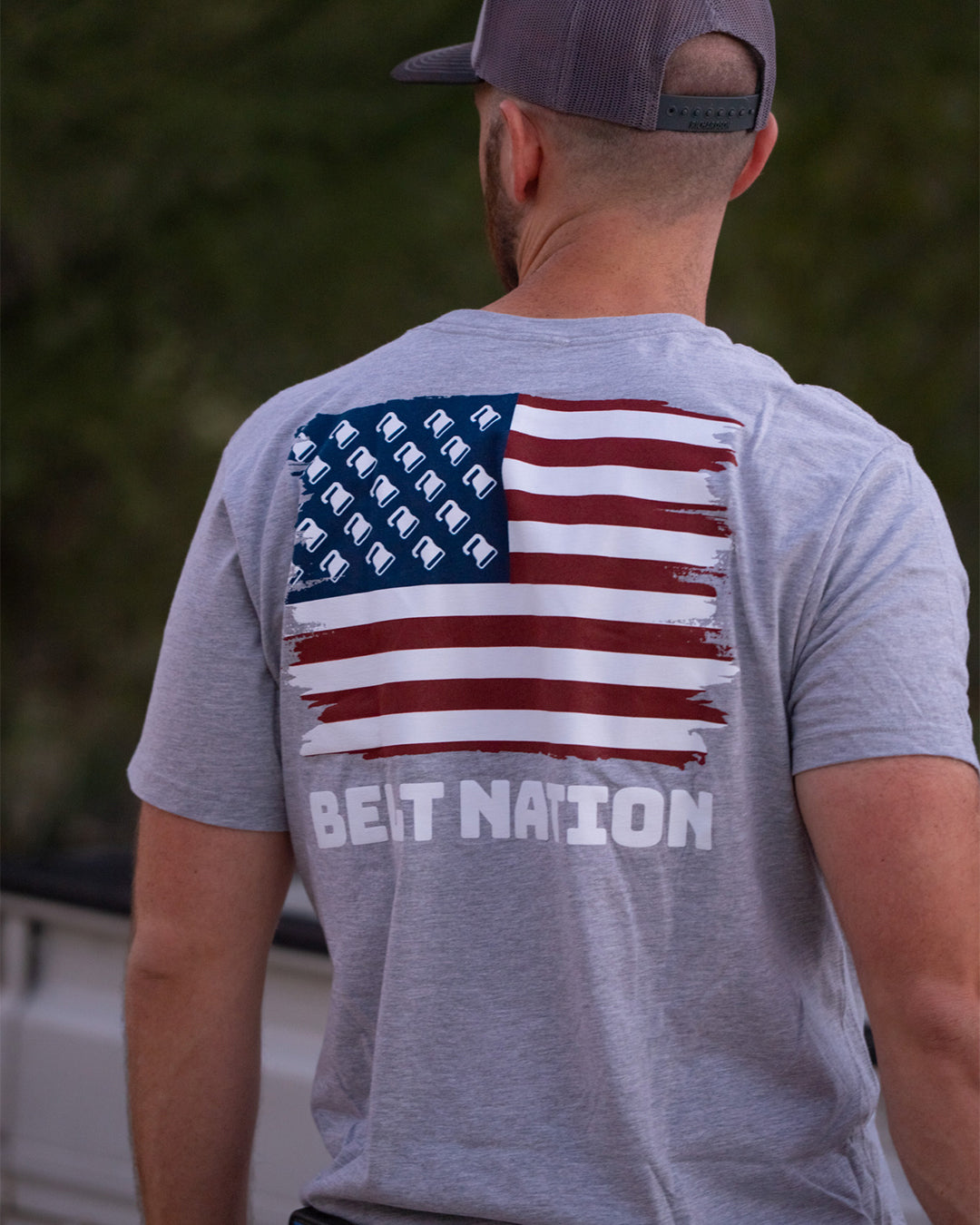 Back view of a man outdoors in the Belt Flag Tee