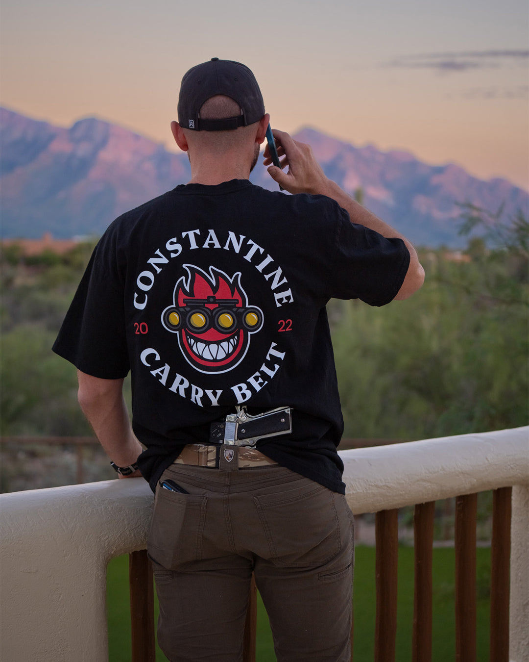 Back view of the Spitfire Belt Tee on a man talking on the phone outdoors