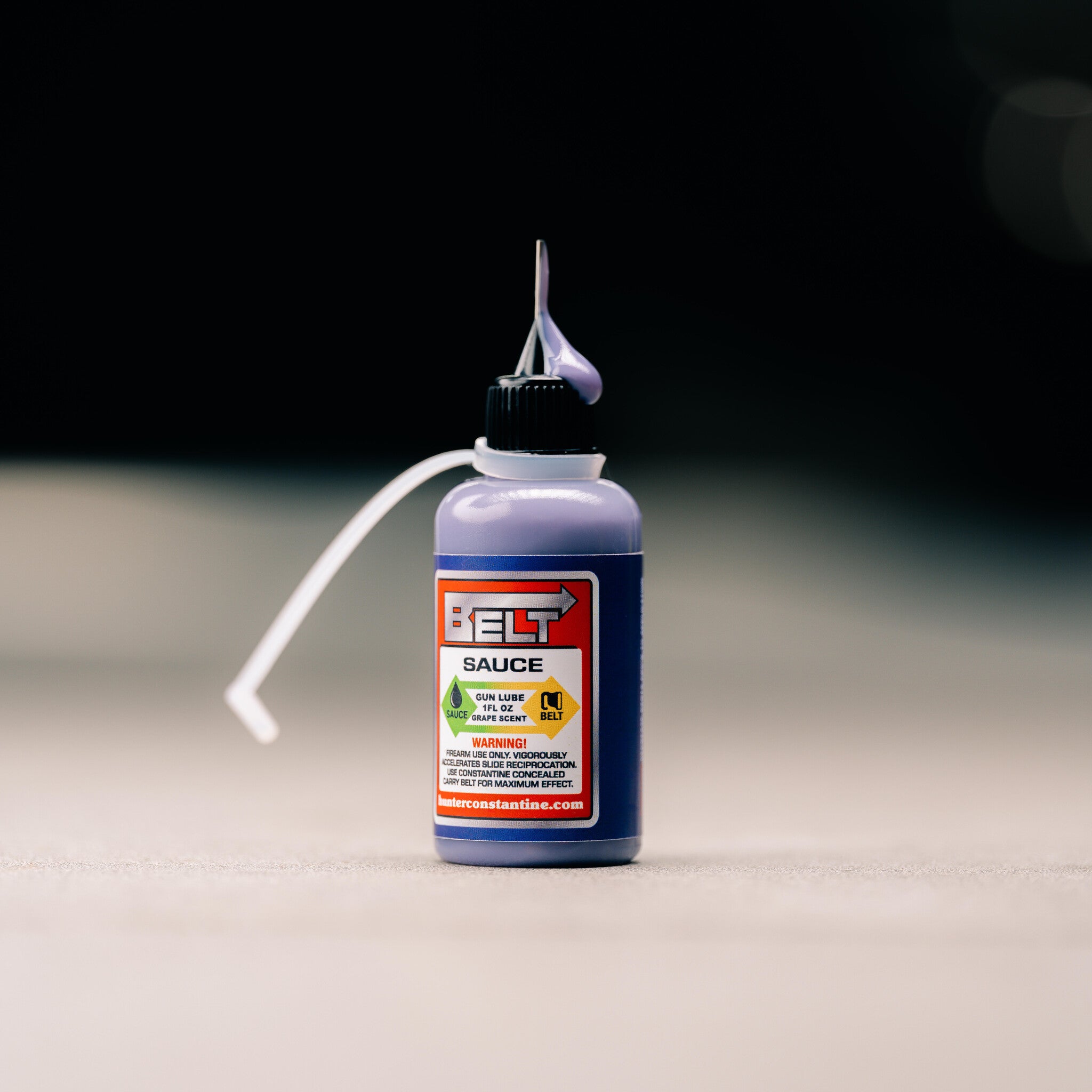 Bottle of 'Belt Sauce' with a label on a neutral background