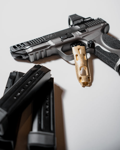 Hunter Constantine Blem S&W M&P9 metal brass grip panel showing textured surface and attachment points for firearm customization.