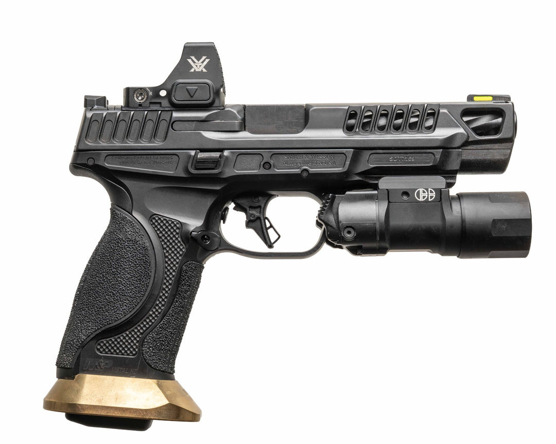 Serialized brass grip insert and magwell installed on a full-size metal-frame M&P pistol
