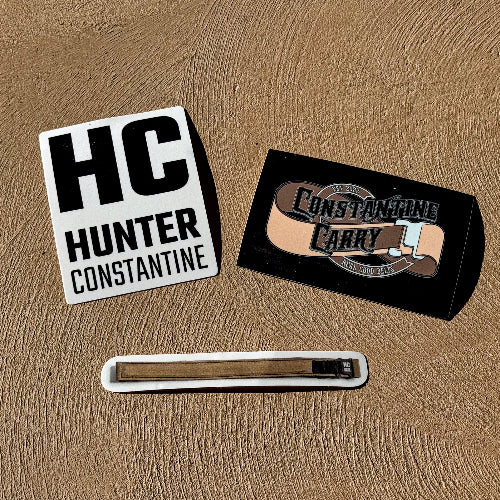 Three stickers on a textured brown surface